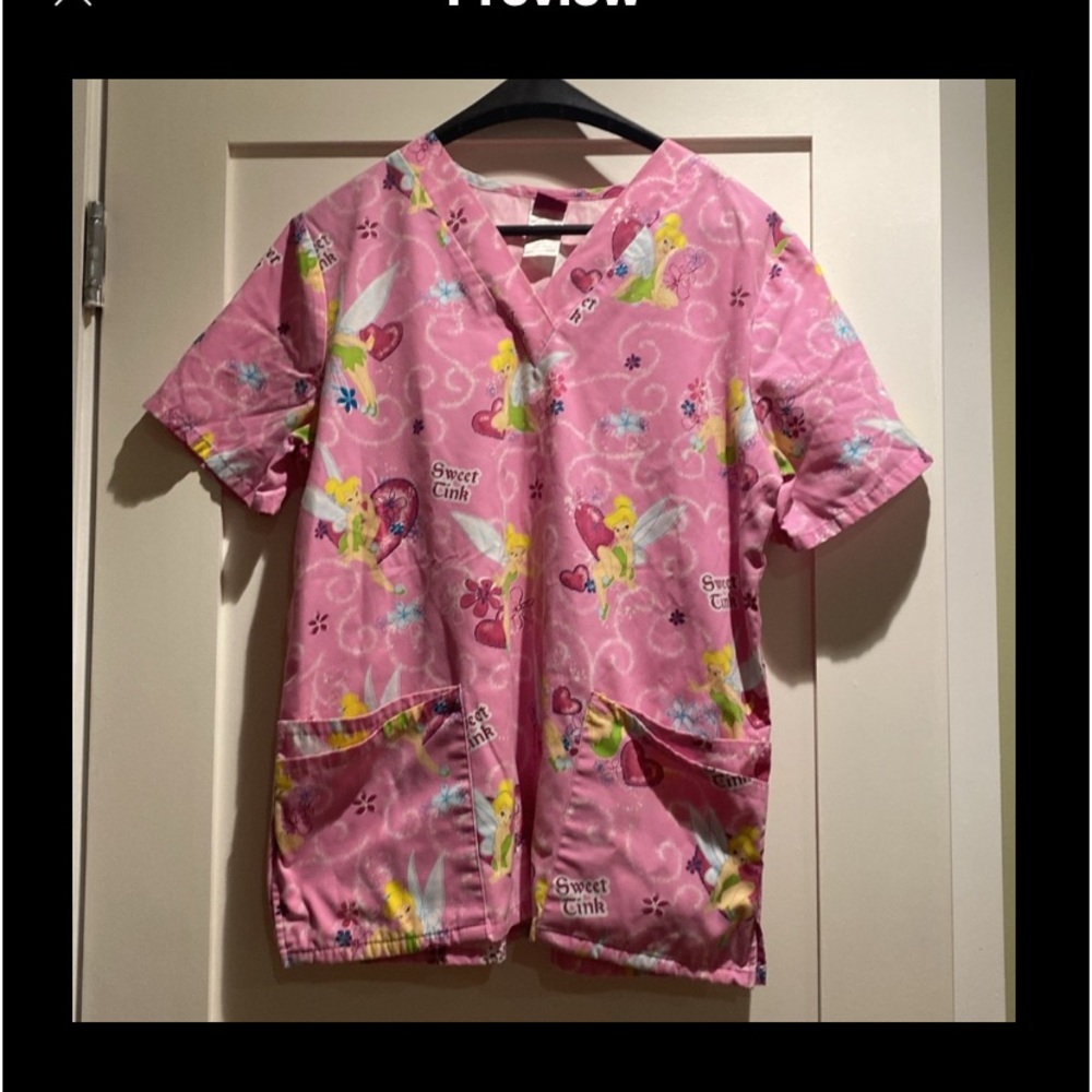 One Tinkerbell scrub. Size medium